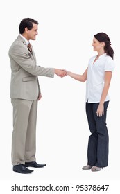 Side View Of Business People Shaking Hands Against A White Background