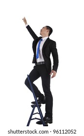 Side View Of A Businessman Climbing A Ladder, Isolated On A White Background.