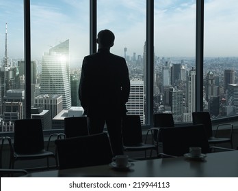 Side View Of A Businessman Looking Through Window, Before Boardroom Meeting