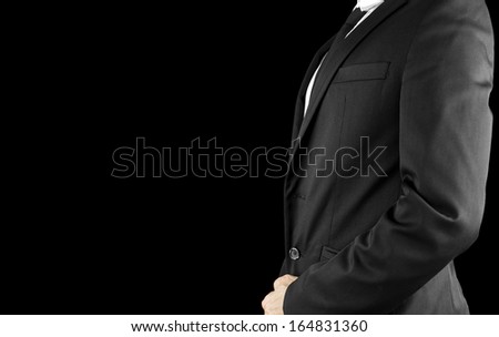 Side view of businessman torso in elegant suit. Isolated over black background. Empty space ready for your text.