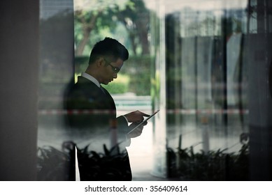 Side view of businessman using application on tablet computer