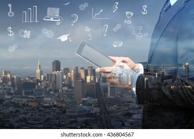 Side view of businessman using tablet with business sketches on city background. Double exposure - Powered by Shutterstock - Get 15% off with code: PIKWIZARD15
