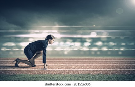 Side view of businesswoman in suit ready to run - Powered by Shutterstock