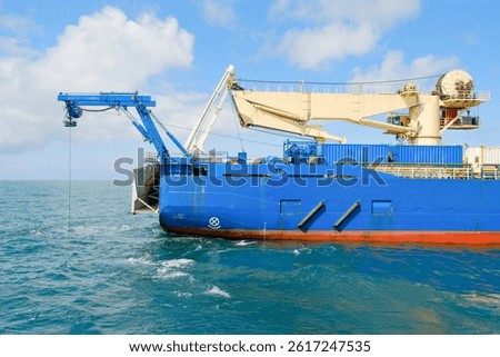 Side View of Cable Laying Vessel with ROV Deployment and Heavy Lift Crane Offshore
