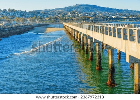 Side view of the Cabrillo Pier in San Pedro, California, set against the cityscape.