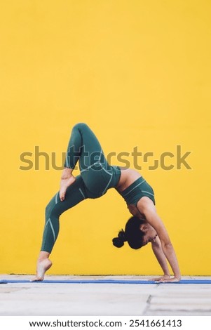 Similar – Woman doing a handstand on the beach