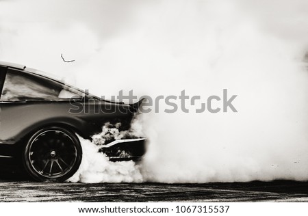 Side view car drifting on track with grain, Sport car wheel drifting and smoking on track. 