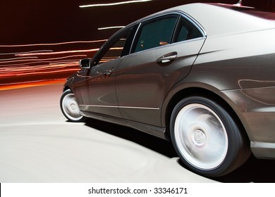 Side View Of A Car Driving Fast In The Night