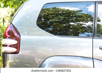 Side view of a car parked on the street in summer sunny day. Mock-up for sticker or decals.