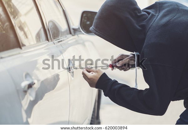 side view of car thief in\
action