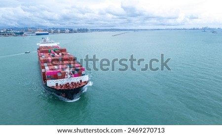 Side view of Cargo container ship carrying container and running out international container port customs shipyard sea port concept smart logistic service. 
