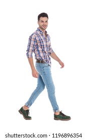 side view of casual man wearing shirt with red plaids stepping on white background, full body picture
