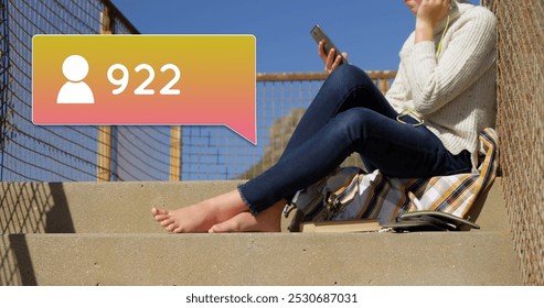 Side view of a Caucasian woman wearing headphones sitting on a stairway. She is taking a selfie beside a follow icon and increasing numbers on a yellow gradient chat box 4k - Powered by Shutterstock - Get 15% off with code: PIKWIZARD15