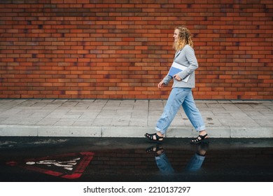 Side View Of A Charming Young Woman Student Holding Laptop Computer, Going To Her Classroom. Back To School University Student. Going To Lessons At College.