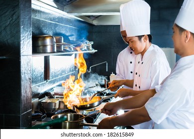 Side View Of Chefs Cooking Together