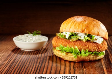 Side View Of Chicken Burger With Lettuce And Mayonnaise Dip On Wooden Table