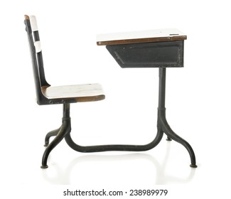 Side view of a child's antique school desk. On a white background.