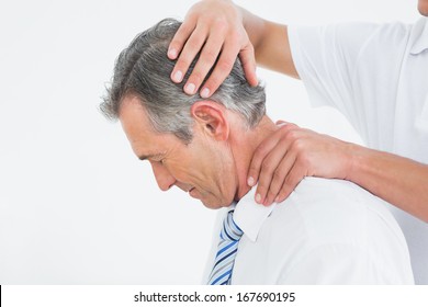 Side View Of A Chiropractor Doing Neck Adjustment