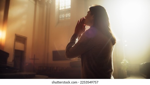 Side View: Christian Woman Getting on her Knees in Front of Altar and Starting to Pray in Church. Devoted Parishioner Seeks Guidance From Faith and Spirituality. Religious Believer in Power of God