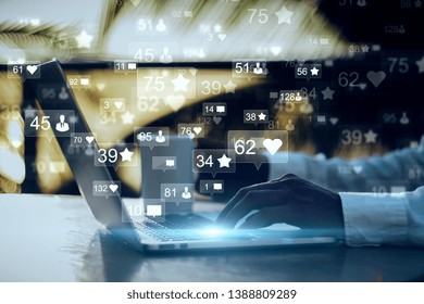 Side view and close up of businessman hands using laptop with social media icons on blurry outdoor background. Communication and network concept. Double exposure  - Powered by Shutterstock