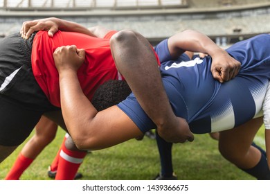 Side view close up of diverse male rugby players playing rugby match in stadium.  - Powered by Shutterstock