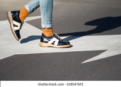 Side View Close Up Of A Fashionable Young Woman Legs Wearing Black Shoes And Blue Jeans Walking From Left To Right On The Street Natural Daylight