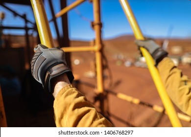 Side View Close Up Good Safety Practice Of Male Miner Wearing A Safety Glove Holding A Hand Rail With Three Point Of Contact While Working On Construction Mine Site, Sydney