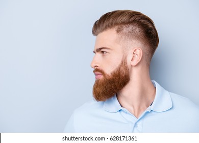 Side view close up portrait of handsome bearded young serious man in polo isolated on copyspace - Powered by Shutterstock