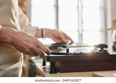 Side view close up of senior woman setting up vinyl record in sunlight copy space - Powered by Shutterstock