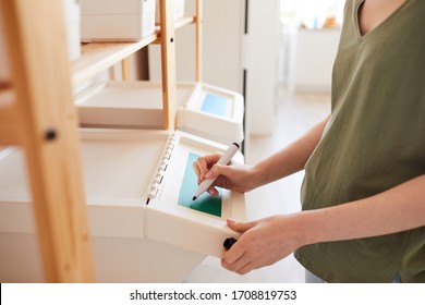 Side View Close Up Of Unrecognizable Woman Labeling Plastic Bins At Home While Managing Storage And Waste Sorting At Home, Copy Space