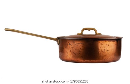 side view closeup of old cooking pan with copper lid and metallic handle isolated on white background