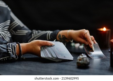 Side View Closeup Of Unrecognizable Black Woman Reading Tarot Cards Over Table In Fortune Tellers Shop