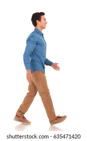 Side View Of A Confident Casual Man Walking Forward On White Background