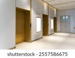 Side view, Contemporary elevator lobby featuring two modern elevators with metal doors on corridor lobby, mockup billboard with frame between elevators, blank space for advertisement or announcement