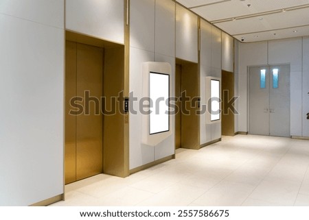 Side view, Contemporary elevator lobby featuring two modern elevators with metal doors on corridor lobby, mockup billboard with frame between elevators, blank space for advertisement or announcement