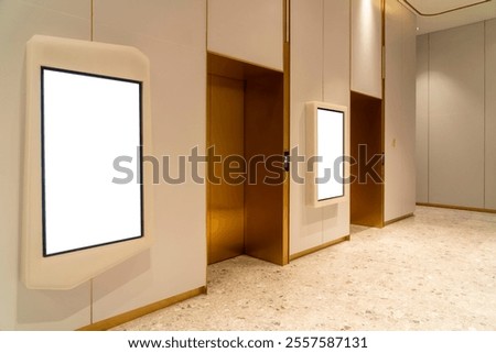 Side view, Contemporary elevator lobby featuring two modern elevators with metal doors on corridor lobby, mockup billboard with frame between elevators, blank space for advertisement or announcement