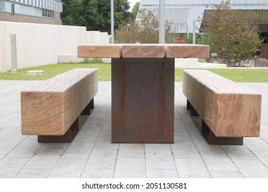 Side View Of A Contemporary Picnic Bench With Seats. Wooden Square Bench In England.