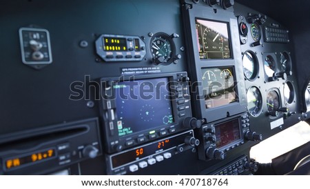 A side view of Control panel of avionics with reflection over the flight instruments.