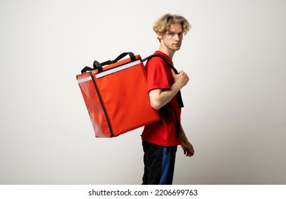 Side view courier guy in red uniform with a thermo blackpack on white background.
