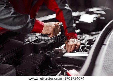 Similar – Image, Stock Photo Anonymous repairman examining car exhaust system in garage
