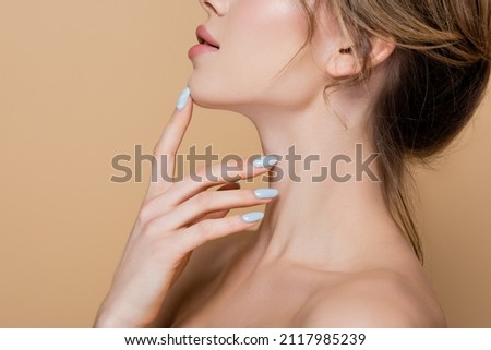 side view of cropped woman with perfect skin touching chin isolated on beige
