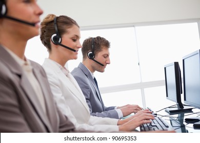 Side View Of Customer Advisory Service At Work