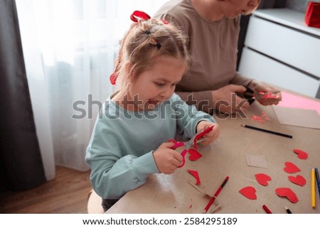 Image, Stock Photo Woman carefully cutting paper design in studio