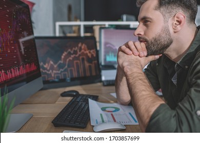 Side View Of Data Analyst Developing Protection For Computer Systems With Computer In Office