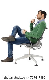 Side View Of Daydreaming Young Man Sitting In Swivel Chair. Full Size.