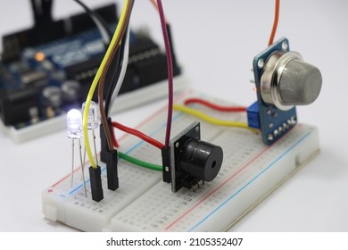 Side view of Different electronic components on a breadboard circuit with microcontroller on the background showing the concept of prototyping