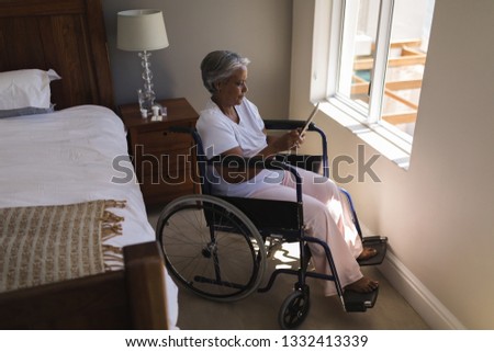 Similar – Senior woman in a wheelchair alone in a room