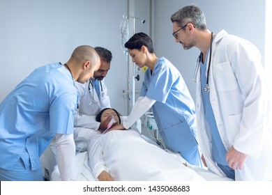 Side view of diverse doctors examining Asian female patient in bed in ward at hospital.  - Shutterstock ID 1435068683