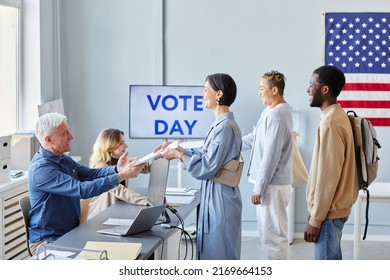 Side View At Diverse Group Of People In Line At Voting Station On Election Day, Copy Space