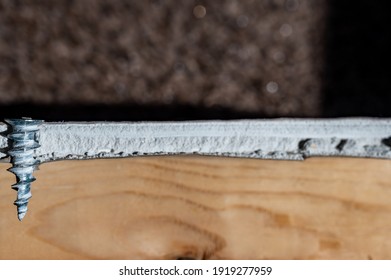 Side View Of A Drywall Mount Anchor And Screw For Hanging Objects On Interior Walls